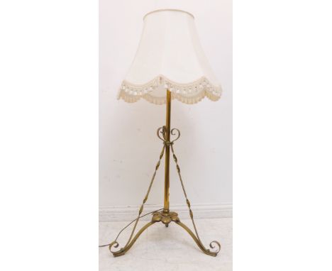 An early 20th century Arts and Crafts style wrought brass adjustable lamp standard