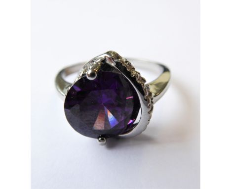 A lady's silver ring: centrally set with a faceted hand-cut amethyst and flanked by a pierced band, ring size P (boxed)