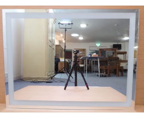 A large and modern wall-hanging mirror with 'defogger' electrical facility to rear (mirror plate size 119.5cm x 90.5cm)