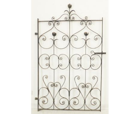 A wrought-iron gate with decorative scrollwork (121 cm wide x 204 cm high).