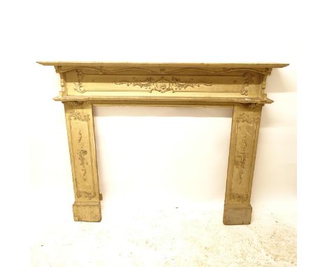 A Victorian painted pine fire surround, with applied scroll decoration, W155cm, H130cm, rebate width 101cm and height 95cm 