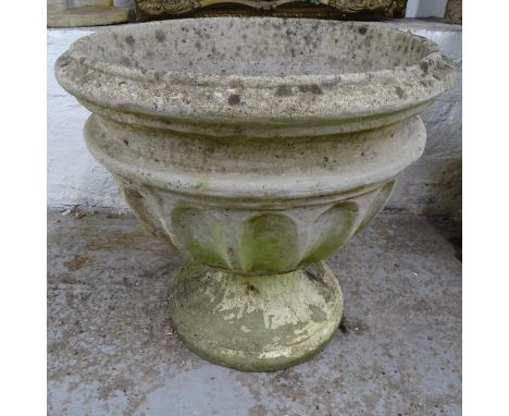 A weathered concrete circular garden urn on stand, D56cm, H55cm 