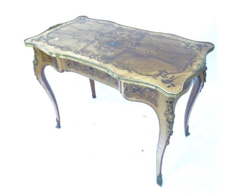 A French ormolu mounted centre table with shaped top and frieze having extensive mother of pearl, walnut, satin wood and king