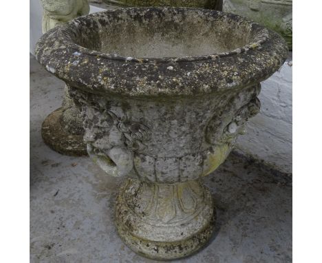 A weathered concrete circular garden urn on stand, D54cm, H65cm 