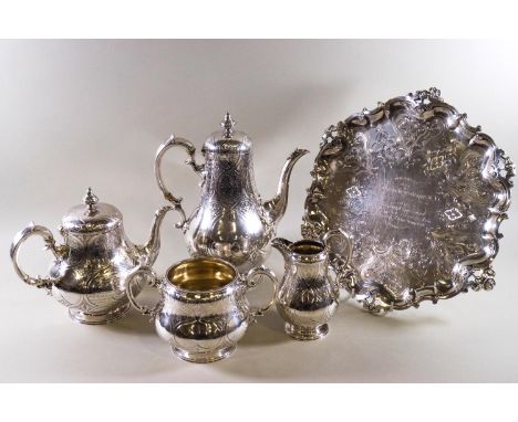 A four piece silver tea service of baluster form with engraved strap work decoration and bead edging, engraved with a present