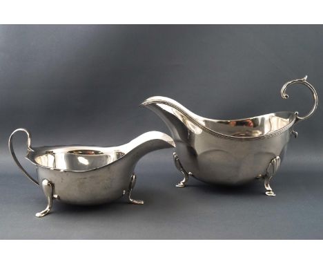 A silver sauce boat by Aitchison Brothers, the panel body raised on three scroll feet and set with a flying scroll handle, Bi