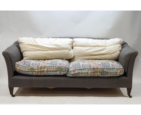 A Howard &amp; Sons sofa on square tapering legs, the brass casters stamped and one leg stamped Howard &amp; Sons, Berners St