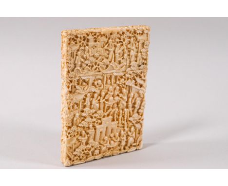 A late 19th century Canton ivory carved card case, with pull off cover, deeply cameo carved with figures in a wooded landscap