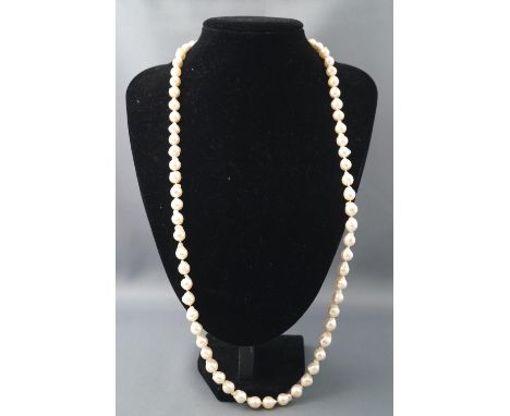 A baroque cultured pearl necklace having seventy pearls strung knotted with a white metal push in clasp set with a 5.00mm cul