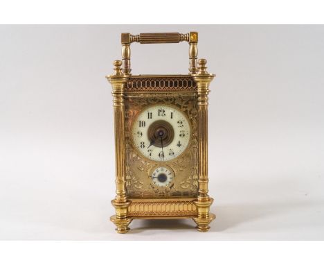 An Edwardian carriage clock with alarm dial, the four glass case enclosing an engraved and pierced rectangular dial with ivor