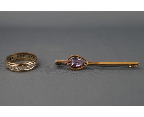 A 9ct gold white sapphire full eternity ring, Size K, and a 9ct amethyst set bar brooch with base metal pin. Gross weight: 5.