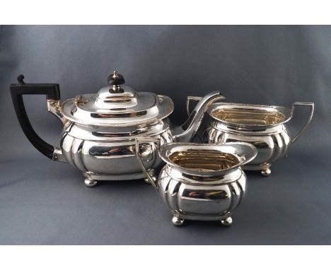 A silver plated three piece tea service, of boat form on ball feet