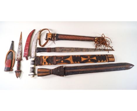 Four African knives, three with leather scabbards and another with a wooden scabbard