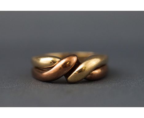 A yellow and rose metal two band puzzle ring, polished finish. Hallmarked 9ct gold, Birmingham. Size: R 7.3 grams
