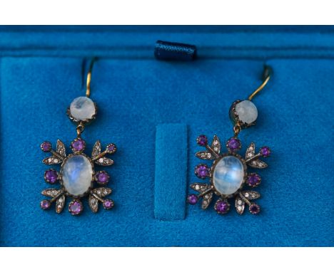 A 9ct and silver gilt pair of drop earrings each set with moonstones, amethyst and rose cut diamonds. Hook fitting. 4.7 grams