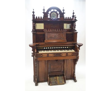 A Victorian carved hardwood harmonium by the Chicago Cottage Organ Company via Crane and Sons, Liverpool, the overshelf set w