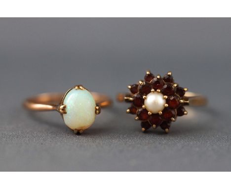 A selection of two dress rings to include a yellow metal single stone cabochon opal ring, size: N stamped 9ct together with a