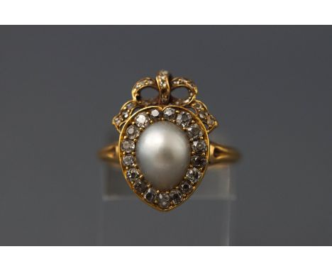 A late 19th century yellow metal pearl and diamond cluster ring set with a central light grey pear drop pearl and old cut dia