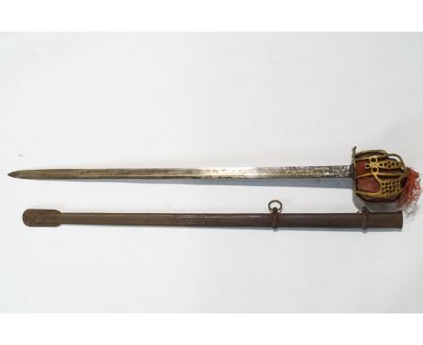 A Scottish sword with a pierced and decorated brass guard to a plain steel blade cased in a metal scabbard with two suspensio