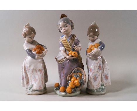 Three Lladro figures: Miss Valencia, 20cm high, with box, and a pair of girls holding oranges, 17.5cm high