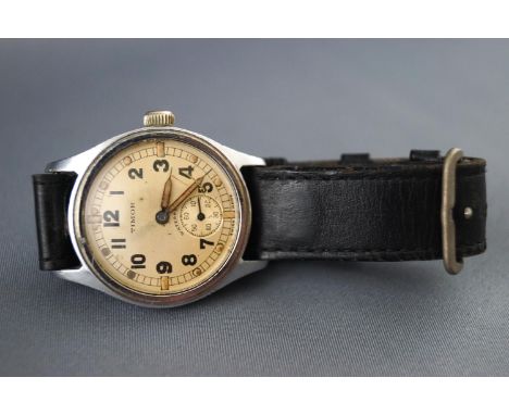 A WWII Timor military wrist watch with leather strap, engraved ATP. Manual wind movement with champagne figure dial. 34.7 gra