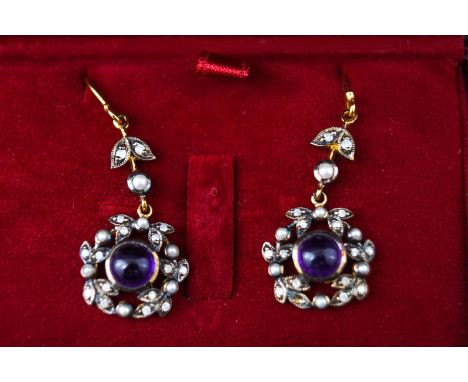 A 9ct and silver gilt pair of drop earrings designed as an ornate floral cluster set with a round cabochon amethyst and surro