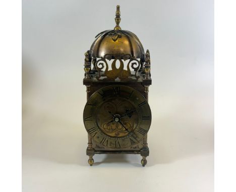 A brass lantern clock approx 29cm tall. Movement has been replaced with a quartz movement