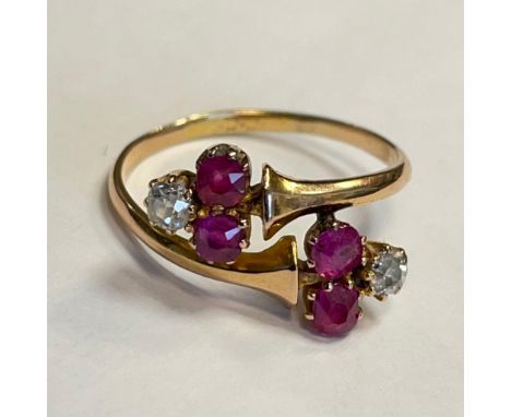 Ruby and diamond 22ct gold ring. Four rubies and two diamonds set in a wrap around ring design. Ring size Q. Approximately 3 