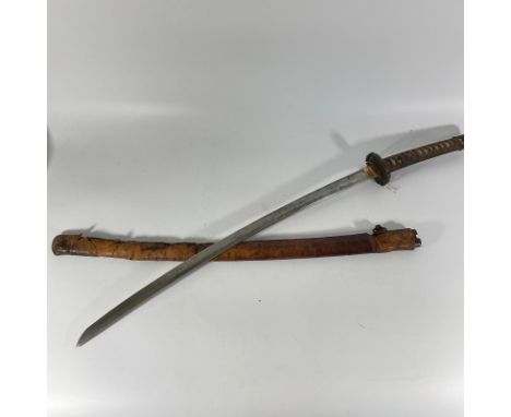 A WWII period Japanese Samurai Sword with shagreen grip and leather outer scabbard.
Blade approximately 71cm condition genera