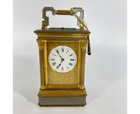 A good quality brass and gun metal carriage clock striking on a gong with repeat - approx 20cm tall, numbered 3264 with ongon