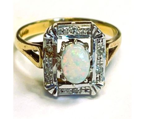 Oval opal 9ct gold ring in rectangular Art Deco setting with small diamonds. Head approximately 12 x 10mm. Size P. Approximat