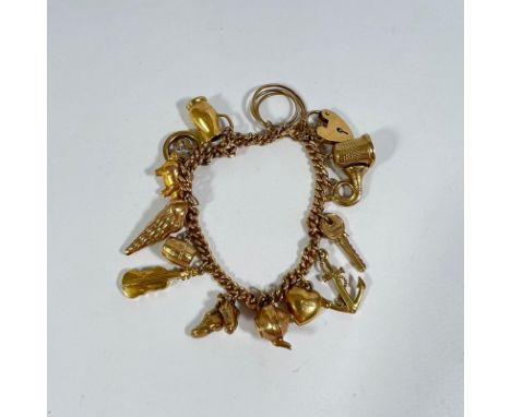 21g - 375 gold charm bracelet with 14 charms, including teapot, shell, heart, thimble, violin, anchor, tuba, football boots.