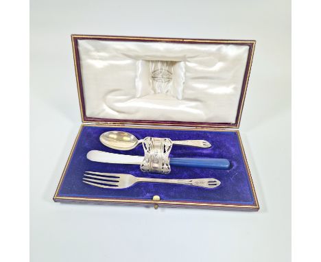 A George V Sterling silver uninitialed christening set, comprising a pierced work and floral spoon, fork and napkin ring plus