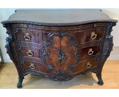 A good quality Georgian style mahogany commode chest in the Louis XV fashion with a slide above two doors enclosing three Oak