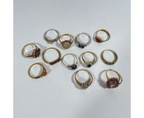 A collection of 9ct gold rings (12) in total. Including:
- 375 gold diamond cluster, size 'R'
- 375 red stone dia cluster, si