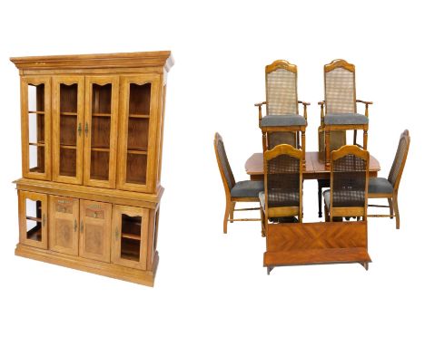 A 20thC American oak extending dining table, the rectangular top with a rounded edge, raised on twin pedestals on shaped feet
