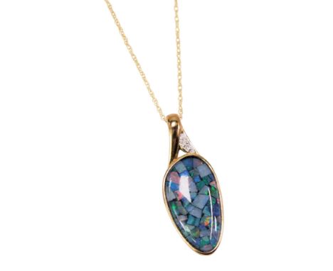 An imitation opal pendant and chain, the oval shaped opal fragment pendant set with three czs, in yellow metal frame stamped 