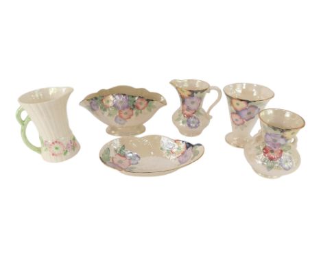 A group of Maling lustreware, each piece decorated with flowers against an off white ground, to include jug, 17cm high, oval 