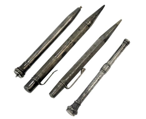 Four silver cased pencils, comprising one with a citrine top, of floral design, and three of engine turned decoration, 2.33oz