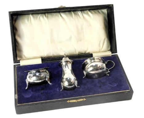 A silver plated three piece cruet set, comprising mustard, salt and pepper, in fitted case.