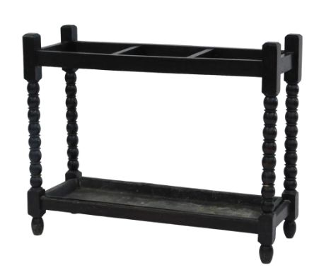 A 20thC stained oak umbrella or stick stand, with three divisions, on turned bobbin supports, with metal drip tray, 66cm high