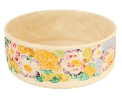 A Clarice Cliff relief moulded pottery fruit bowl, decorated with a band of flowers against an off white ground, printed mark