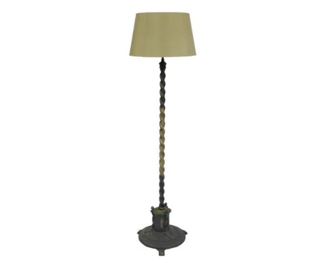 An early 20thC brass standard lamp, the spiral twist column above a lower cylindrical section, with three shaped finials, abo