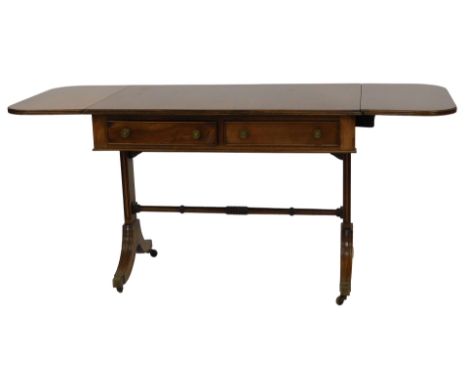 A mahogany sofa table, the drop leaf top with a rounded edge above two frieze drawers, raised on two reeded end supports with