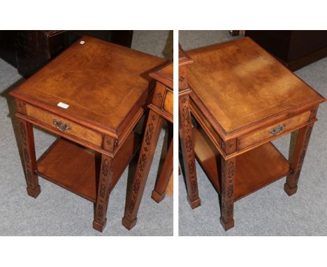 A pair of reproduction crossbanded burr walnut bedside tables, each fitted with a drawer and shelf stretcher, the legs decora