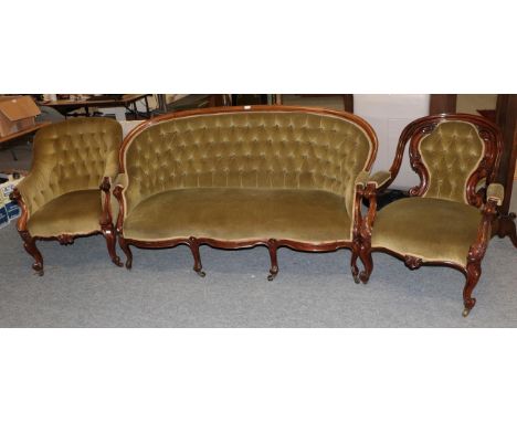 A Victorian mahogany framed sofa upholstered in buttoned green fabric and two similar armchairs (3)