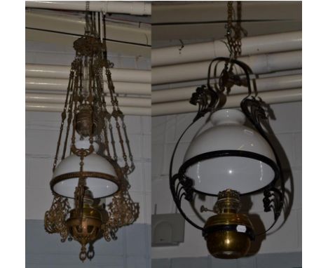 A 19th century brass and wrought iron hanging oil lamp, along with a similar rise and fall example (a.f.) (2)