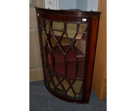 A George III mahogany bow-fronted handing corner cupboard, 67cm by 42cm by 104cm high