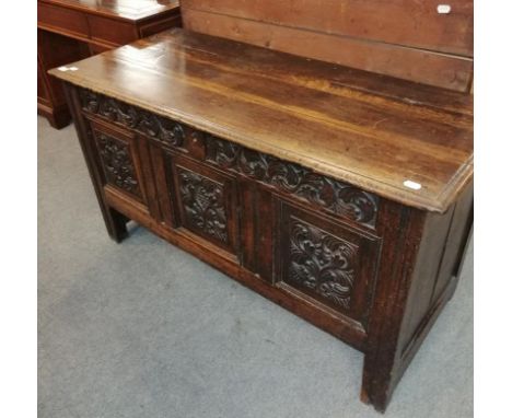 An 18th century carved oak three panel coffer, 130cm by 56cm by 73cm high