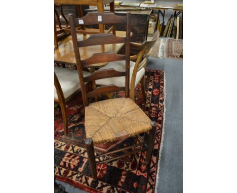 A pair of ladder back dining chairs.